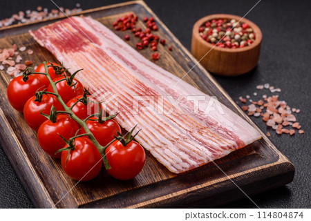 Delicious bacon in the form of slices with salt, spices and herbs 114804874
