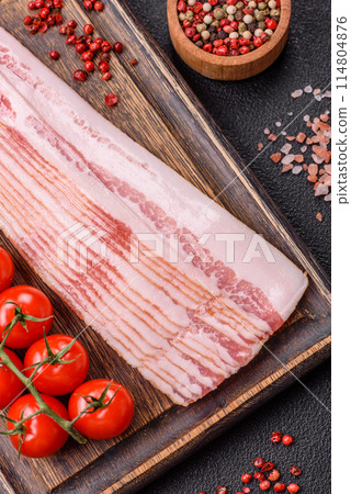 Delicious bacon in the form of slices with salt, spices and herbs 114804876