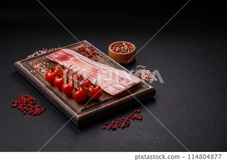 Delicious bacon in the form of slices with salt, spices and herbs 114804877