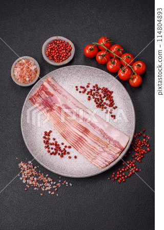 Delicious bacon in the form of slices with salt, spices and herbs 114804893