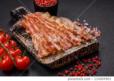 Delicious bacon in the form of slices with salt, spices and herbs 114804901