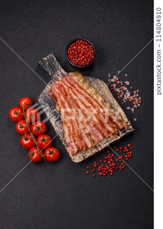 Delicious bacon in the form of slices with salt, spices and herbs Delicious bacon in the form of slices with salt, spices and herbs 114804910