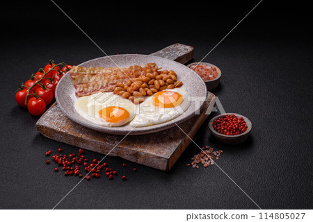 English breakfast with fried eggs, bacon, beans, tomatoes, spices and herbs 114805027