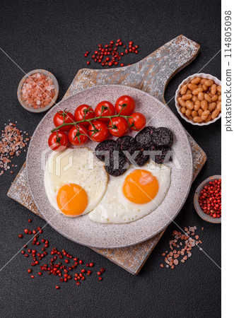 English breakfast with fried eggs, bacon, beans, tomatoes, spices and herbs 114805098