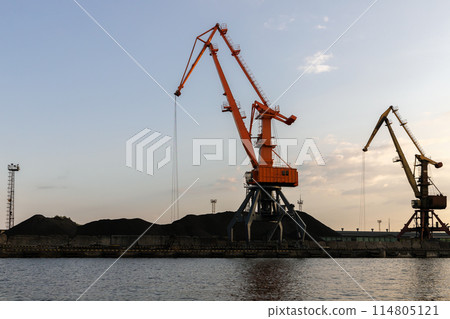 Silhouettes of harbour portal cranes at the sea port 114805121