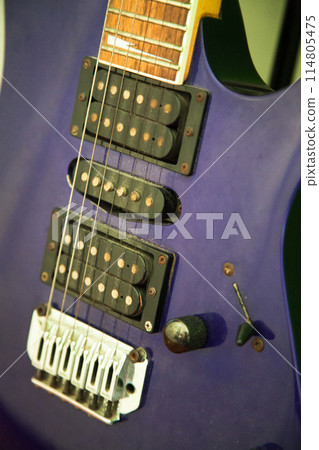 Electric guitar bridge, strings and pickup, detail close-up view of guitar pickup in blue 114805475