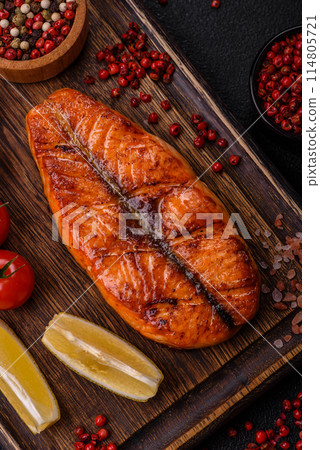Fresh cooked delicious salmon steak with spices and herbs 114805721