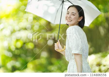 A young woman holding a parasol A young woman holding a parasol 114806556