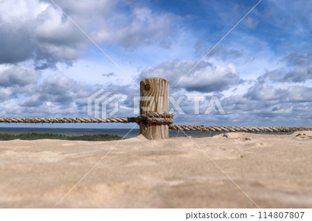 Pillar covered in sand on the hiking trail through the Lacka gora dune near Leba village  in the Slovincian National Park 114807807