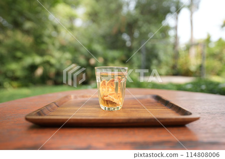 Bael tea glass cup on wooden table 114808006