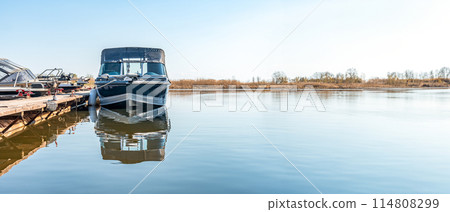 Fishing boats moored at wooden pontoon pier in morning Fishing boats moored at wooden pontoon pier in morning 114808299
