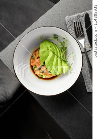 Salmon tartare with cucumber, avocado and Pan Asian sauce 114808935