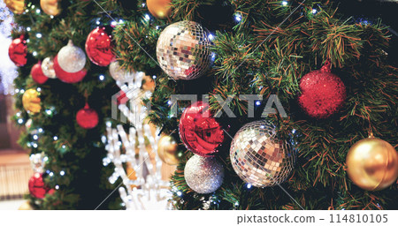 Colourful glittering baubles ornament ball decorated christmas tree on holiday winter xmas happy new year festival celebration. Red, gold, silver ball on Christmas tree. Merry Christmas happy new year Colourful glittering baubles ornament ball decorated christmas tree on holiday winter xmas happy new year festival celebration. Red, gold, silver ball on Christmas tree. Merry Christmas happy new year 114810105