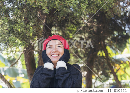 Portrait Asian Woman relaxing in green park. Happy Relax asian woman smiling face at outdoors garden. Young women enjoy nature freedom lifestyle. Greenery wellbeing outside beauty in nature. Portrait Asian Woman relaxing in green park. Happy Relax asian woman smiling face at outdoors garden. Young women enjoy nature freedom lifestyle. Greenery wellbeing outside beauty in nature. 114810351