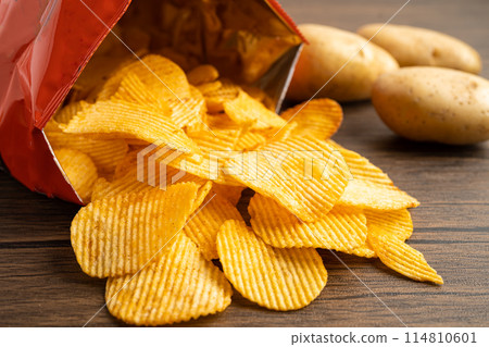 Potato chips, delicious BBQ seasoning spicy for crips, thin slice deep fried snack fast food in open bag. Potato chips, delicious BBQ seasoning spicy for crips, thin slice deep fried snack fast food in open bag. 114810601