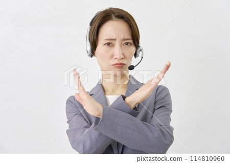 Operator making a cross gesture with his hand on a white background Operator making a cross gesture with his hand on a white background 114810960