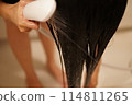 A woman getting shampooed 114811265