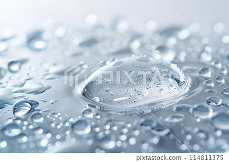 A close up of a drop of water resting on a surface 114811375