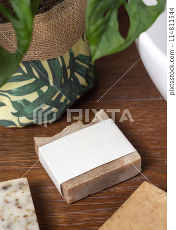 Soap bar with blank label on bath wooden countertop near green plant close up, mockup Soap bar with blank label on bath wooden countertop near green plant close up, mockup 114811544