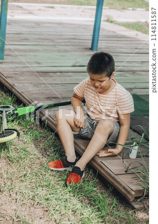 The First Bandage: A child's initiation into the world of first-aid, showing determination and care in the face of minor adversity. The First Bandage: A child's initiation into the world of first-aid, showing determination and care in the face of minor adversity. 114811587