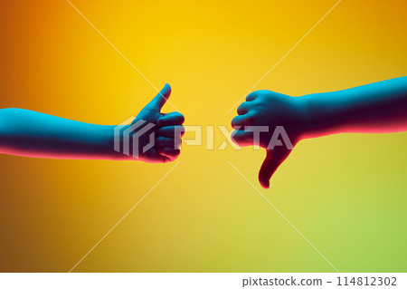 Opposing Opinions. One hand offers thumbs up in approval, while other hand delivers thumbs down in disapproval. Opposing Opinions. One hand offers thumbs up in approval, while other hand delivers thumbs down in disapproval. 114812302