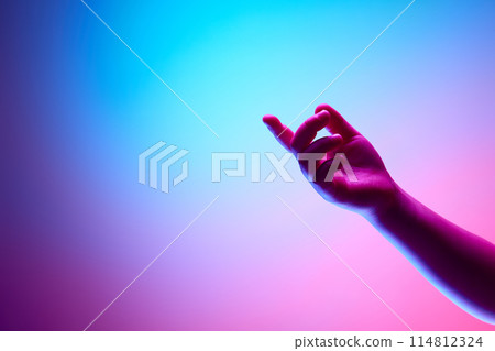 Look Here. Children hand pointing with finger against multicolored background in neon light. Look Here. Children hand pointing with finger against multicolored background in neon light. 114812324