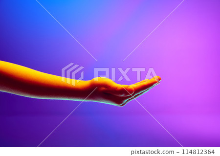 Kids hands gesturing with open palm against gradient blue purple background in neon light. Kids hands gesturing with open palm against gradient blue purple background in neon light. 114812364