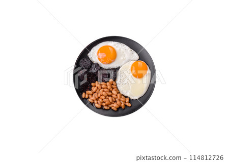 English breakfast with fried eggs, bacon, beans, tomatoes, spices and herbs English breakfast with fried eggs, bacon, beans, tomatoes, spices and herbs 114812726