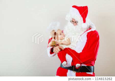 Man wearing santa claus costume holding baby Man wearing santa claus costume holding baby 114813262