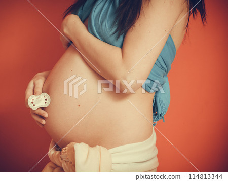 pregnant woman with dummy for unborn baby pregnant woman with dummy for unborn baby 114813344