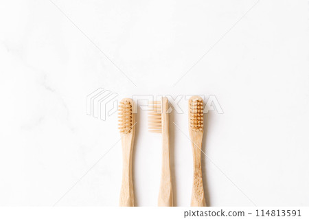 Three eco-friendly bamboo toothbrushes on white background. Three eco-friendly bamboo toothbrushes on white background. 114813591