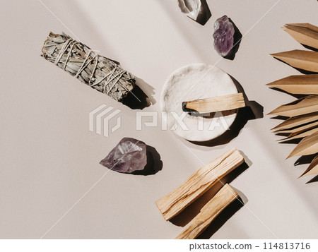 White sage and Palo Santo and amethyst and quartz crystals on a light beige background 114813716