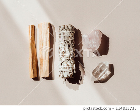 White sage and Palo Santo and amethyst and quartz crystals on a light beige background 114813733