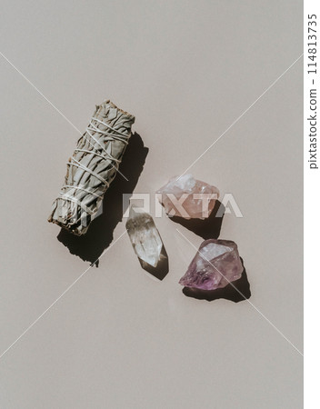 White sage and amethyst and quartz crystals on a light beige background 114813735
