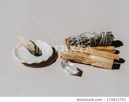 White sage and Palo Santo on a light beige background. A set of incense for fumigation 114813781