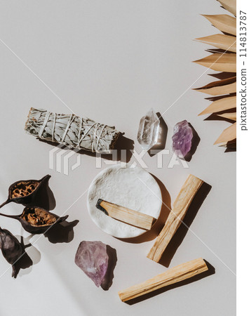 White sage and Palo Santo and amethyst and quartz crystals on a light beige background. 114813787
