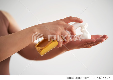 Hands hold a savory facial foam demonstrating its texture. Hands hold a savory facial foam demonstrating its texture. 114815597