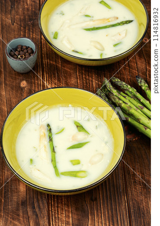 Asparagus soup on wooden background. 114816932