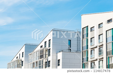 European residential building, modern apartments with balconies, blue sky backdrop. Investment in 114817478