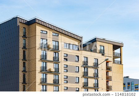 Luxury modern residential condominium, urban environment with blue sky. European style facade, 114818102