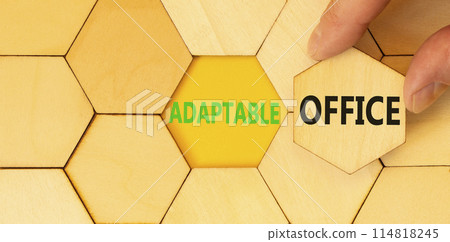 Adaptable office symbol. Concept words Adaptable office on beautiful wooden puzzles. Beautiful yellow background. Businessman hand. Business Adaptable office concept. Copy space. Adaptable office symbol. Concept words Adaptable office on beautiful wooden puzzles. Beautiful yellow background. Businessman hand. Business Adaptable office concept. Copy space. 114818245