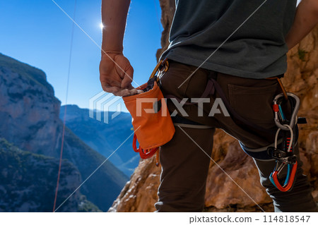 Man is climbing with magnesium powder. 114818547