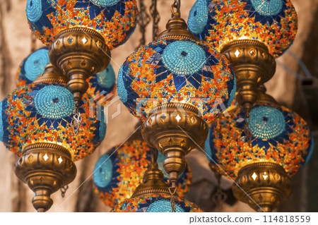 Middle Eastern lambas of different colors and sizes are hanging in the bazaar Middle Eastern lambas of different colors and sizes are hanging in the bazaar 114818559