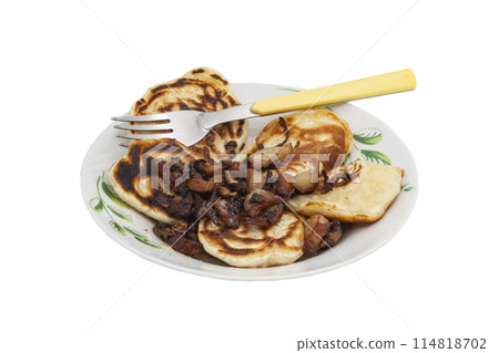 A delicious country breakfast, fried pancakes and meat and onions in a plate with a fork with no background. 114818702
