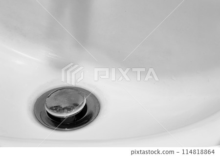 Detail of a ceramic white sink in a modern bathroom with chrome plated drain. Horizontal. For text. Detail of a ceramic white sink in a modern bathroom with chrome plated drain. Horizontal. For text. 114818864