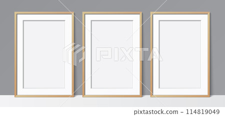 3 blank poster wooden frames leaning against a grey wall, vector mockup. 114819049