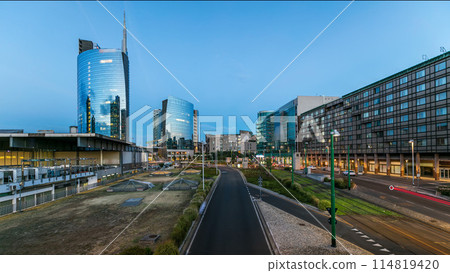 Milan skyline with modern skyscrapers in Porta Nuova business district day to night timelapse in Milan, Italy, after sunset. Milan skyline with modern skyscrapers in Porta Nuova business district day to night timelapse in Milan, Italy, after sunset. 114819420