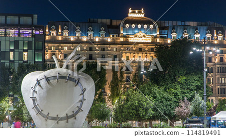 The monumental sculpture The Reintegrated Apple in front of Milan's central railway station night timelapse. The monumental sculpture The Reintegrated Apple in front of Milan's central railway station night timelapse. 114819491