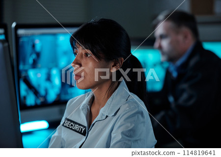Security working in surveillance room 114819641