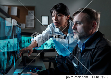 Security guards watching cctv video 114819652